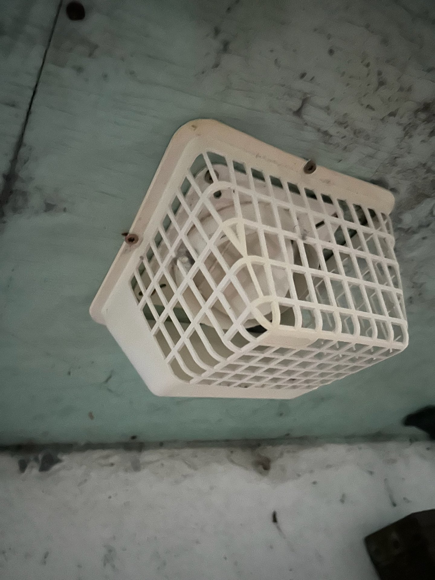 Original plastic vent cap removed from a home