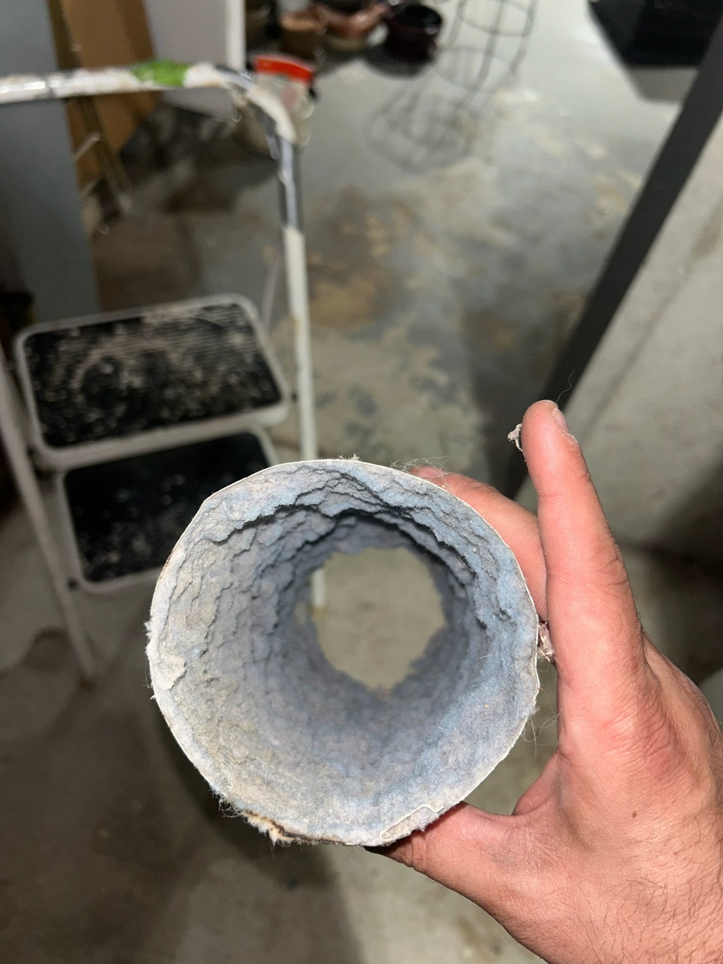 Technician holding a lint chunk pulled from a dryer vent